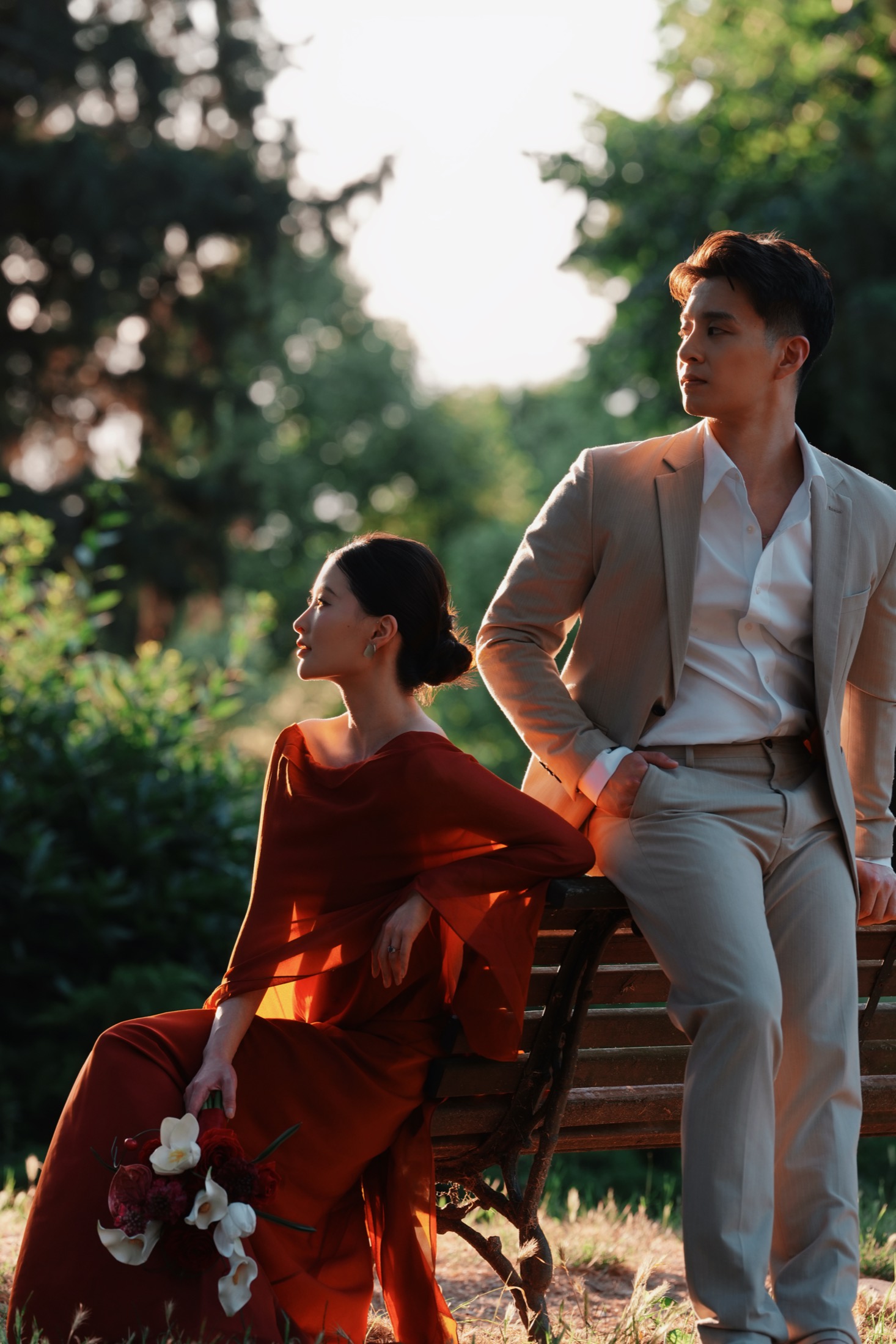 Yue and Andrew on a garden bench in evening light